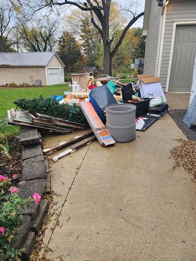 Dumpster being loaded with debris for 12 Yard Dumpster Rental in Choccolocco